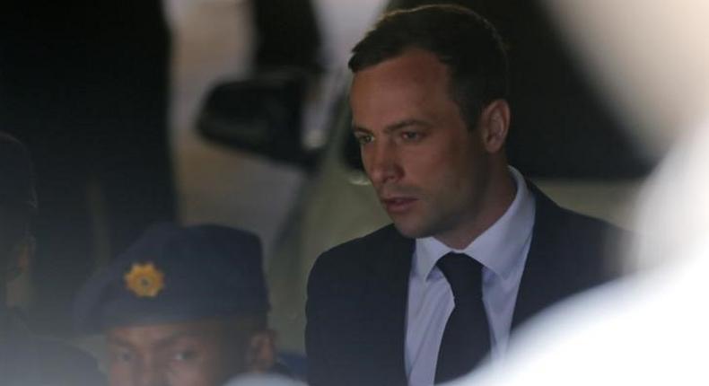 South African Olympic and Paralympic sprinter Oscar Pistorius is led to a prison van after his sentencing in Pretoria October 21, 2014. REUTERS/Mike Hutchings