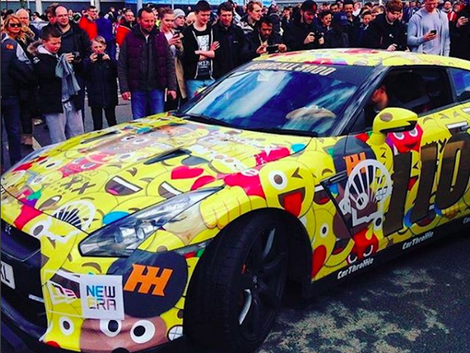 After eventually being let through security, we found the car we would be riding in: a Nissan GTR which had been covered in custom emoji artwork.