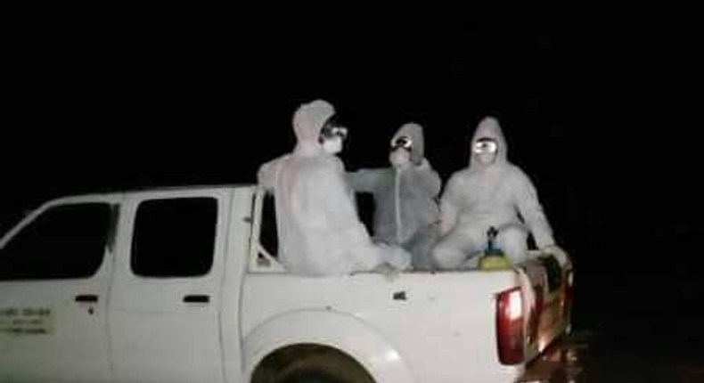 File image of public health officers during a night funeral for a Covid-19 victim  in Siaya County