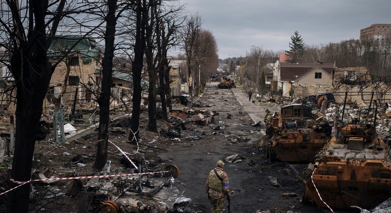 A Ukrainian serviceman walks amid destroyed Russian tanks in Bucha, on the outskirts of Kyiv, Ukraine, April 6, 2022.