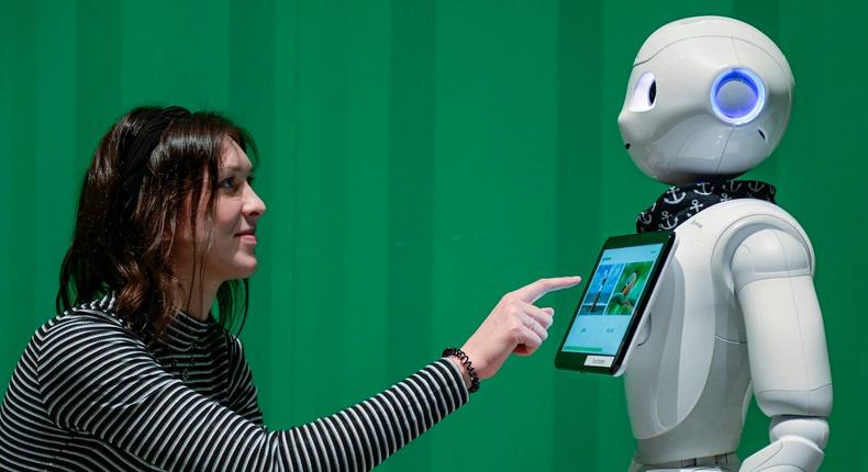 Paulina Kappen, a student of research, development and management in social work at the Kiel University of Applied Sciences, demonstrates the capabilities of a robot used to care for dementia patients, in Hamburg, Germany, November 21, 2019.Axel Heimken/dpa/Getty Images