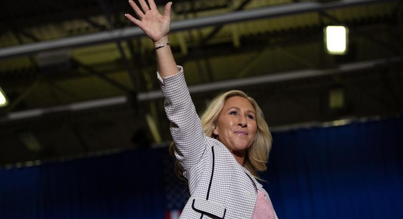 Majorie Taylor Greene waves to the crowd before she makes speaks during a Save America rally on October 1, 2022 in Warren, Michigan