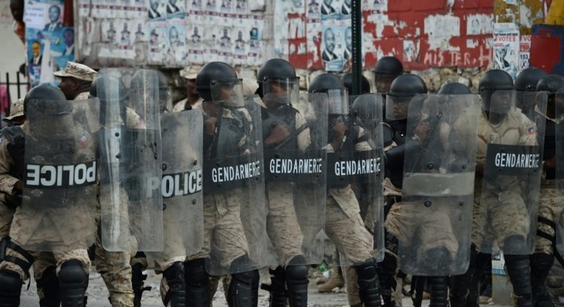 Haitian police confront demonstrators protesting the election of Jovenel Moise as new president of Haiti in Port-au-Prince