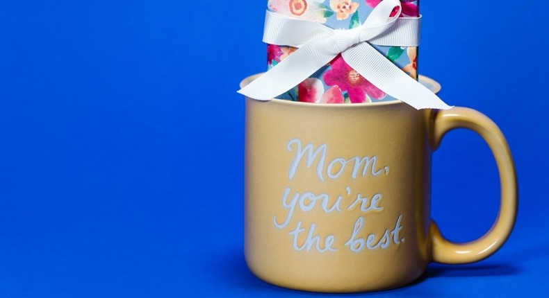 Yellow ceramic mug on blue background [Photo: RODNAE Productions]