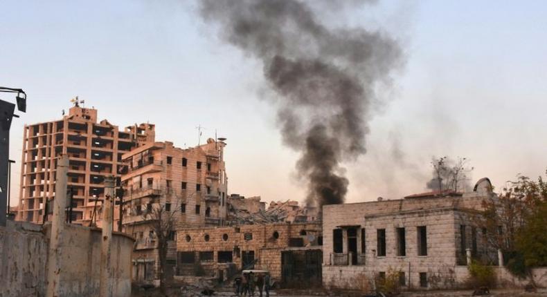 Smoke billows in Aleppo's Bustan al-Basha district on November 28, 2016, during Syrian pro-government forces assault to retake the entire city from rebels