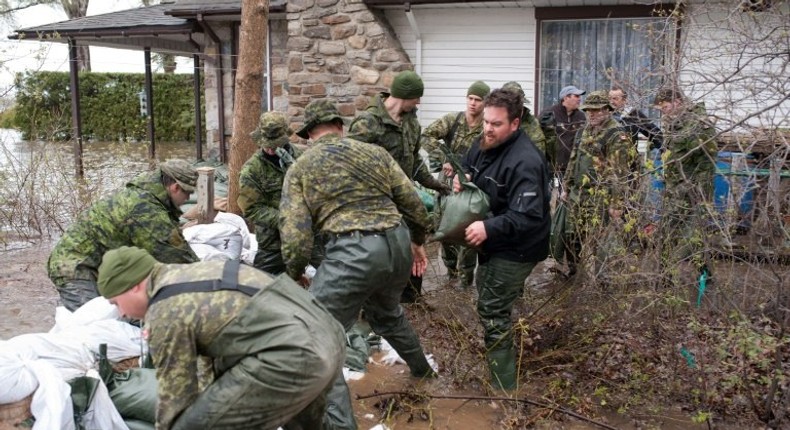 Soldiers help residents of Pierrefonds after heavy flooding caused by unrelenting rain