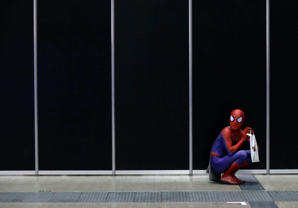 A man in a Spider-Man costume takes a rest at Tokyo Comic Con at Makuhari Messe in Chiba