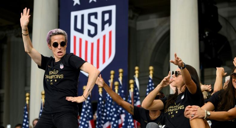 US women's soccer star Megan Rapinoe, left, and her teammates won a court ruling Friday in their fight for equal pay from the US Soccer Federation