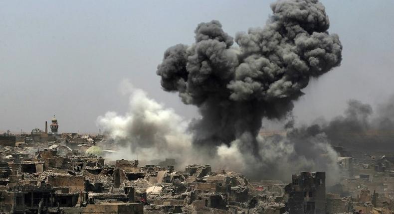 A picture taken on July 9, 2017, shows smoke billowing following an airstrike by US-led international coalition forces targeting Islamic State group in Mosul