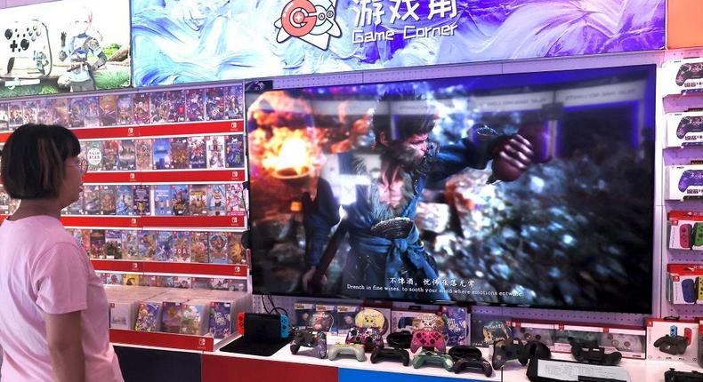 A woman watching gameplay of Black Myth: Wukong inside a video game store.China News Service/Getty Images