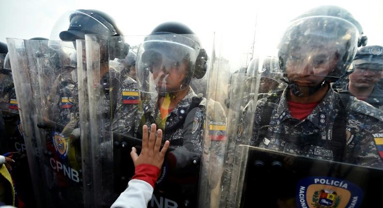 Venezuelans confronted police and demanded that humanitarian aid sent to Colombia be allowed in the country