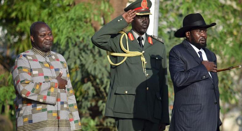 South Sudan's President Salva Kiir (R) and his First Vice President Riek Machar (L) stand during the national anthem after he was sworn-in at the Presidential House in South Sudan's capital Juba, April 26, 2016. 