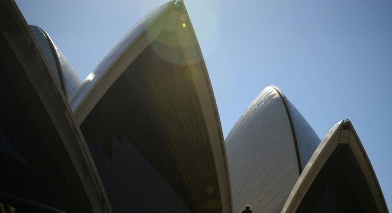 Tourists walk outside the Sydney Opera House on May 10, 2017