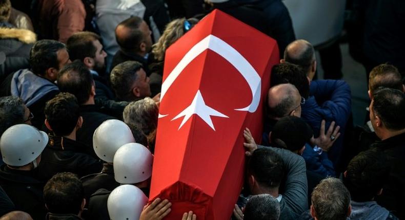 Turkish police carry the coffin of a fellow officer during a funeral ceremony at Istanbul's police headquarters on December 11, 2016