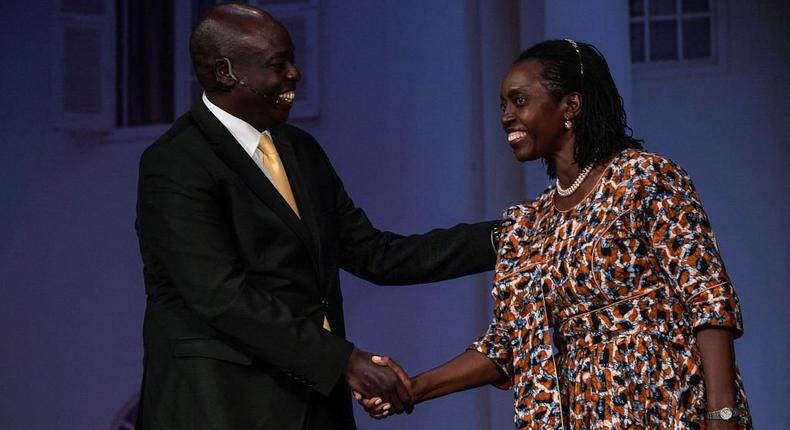 United Democratic Alliance (UDA) Rigathi Gachagua (L) shakes hands with running mate of Azimio la Umoja (aspiration to unite) political alliance Martha Karua after the deputy presidential debate held at the Catholic University of Eastern Africa in Nairobi, on July 19, 2022, ahead of August's general elections. (Photo by SIMON MAINA/AFP via Getty Images)