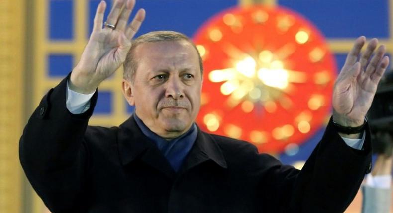 Turkish President Recep Tayyip Erdogan waves to supporters after winning a referendum that greatly enhanced his powers