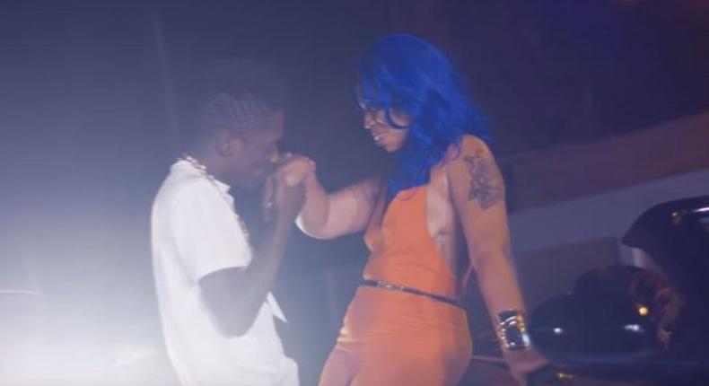 Shatta Wale kisses his baby mama's hands in Chop Kiss music video