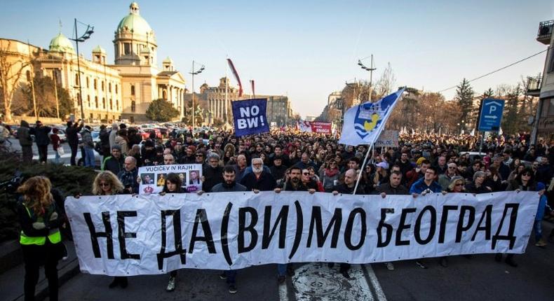 Protesters walk past the Serbian National Assembly building during an anti-government protest in Belgrade on February 15, 2017