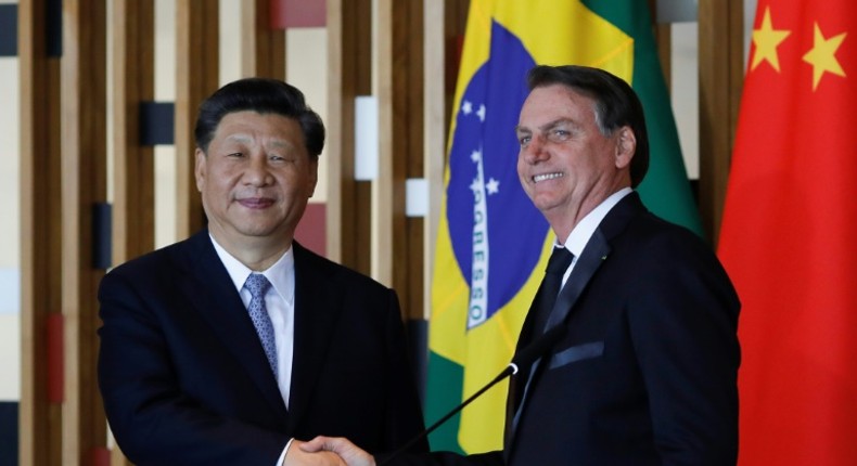 Chinese President Xi Jinping (L) and Brazilian President Jair Bolsonaro after their bilateral meeting in Brasilia on the eve of a BRICS summit