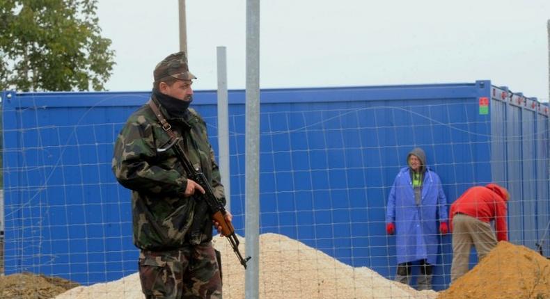 A Hungarian soldier stands guard at the Beremend border station on September 30, 2015