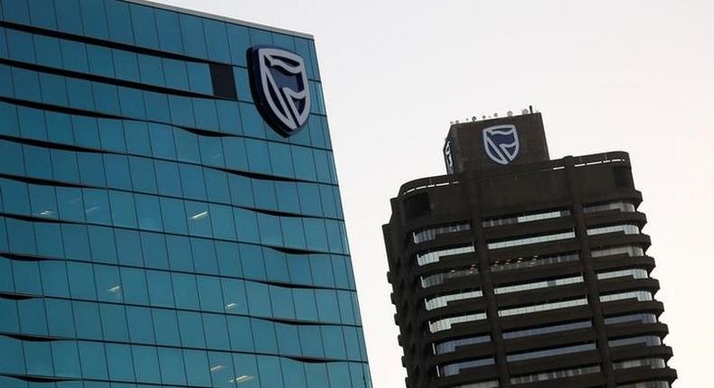 The logo of South Africa's Standard Bank is seen above the company's headquarters in Cape Town, South Africa May 6, 2016. REUTERS/Mike Hutchings/File Photo