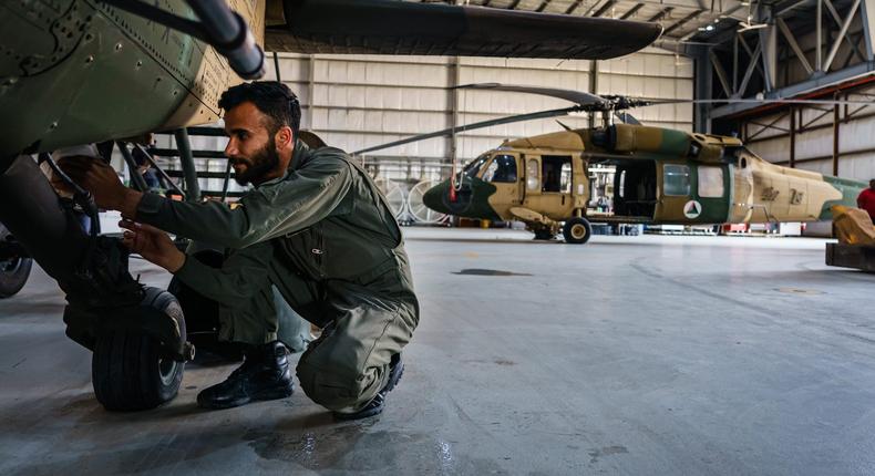 An Afghan air force maintainer works on an UH-60 Blackhawk at Kabul Airbase, May 9, 2021.
