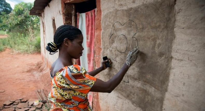 Women in the village of Makwatsha in DR Congo decorate their huts with paintings of local life, a tradition now attracting tourists