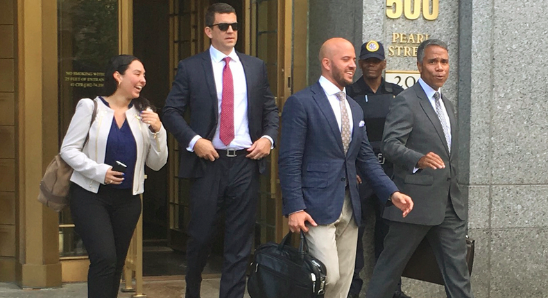 Jonathan Roper, second from left, a former Insys Therapeutics district sales manager, and Fernando Serrano, center, a former sales representative, walk with Serrano's lawyer, Jude Cardenas, right, out of federal court in August.