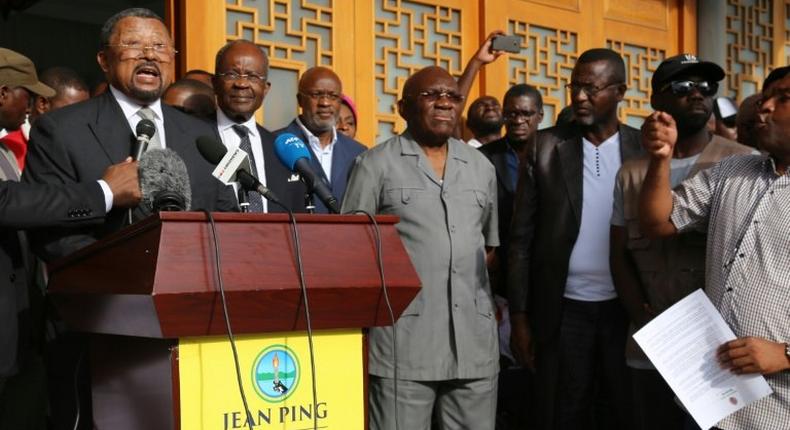 Gabonese opposition leader Jean Ping (L) flanked by opponents Casimir Oye Mba (2L) and Zacharie Myboto (C) speaks to supporters during a press conference in Libreville