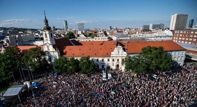 Demonstrators hold up flags of Slovakia and EU during an anti-corruption rally in Bratislava on June 5, 2017