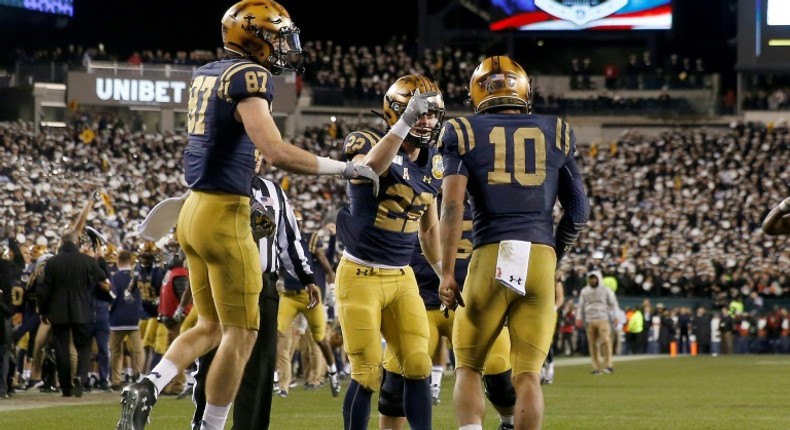 The Navy Midshipmen celebrate a touchdown in Saturday's game against the Army Black Knights