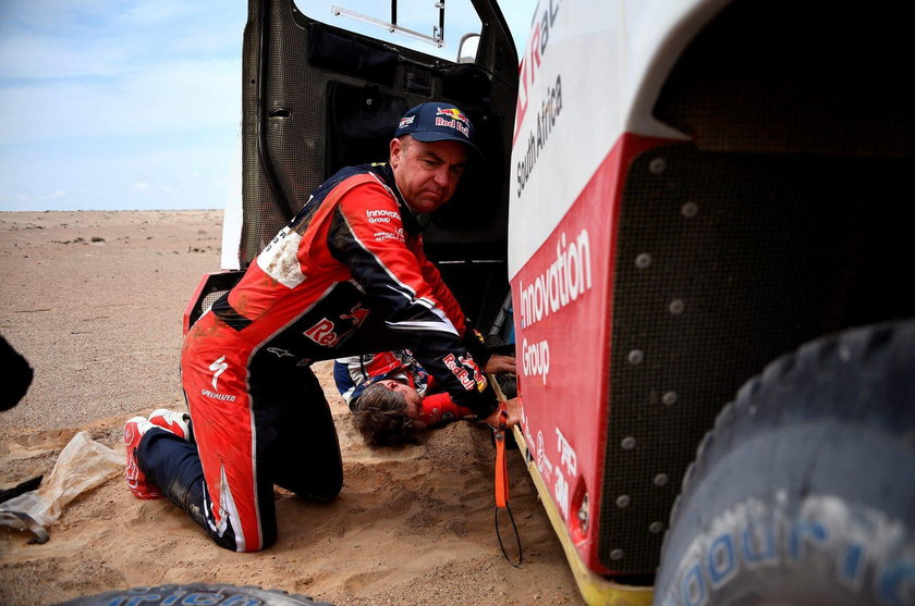 Driver Giniel De Villiers, of South Africa, and co-driver Dirk Von Zitzewitz, of Germany, work on th