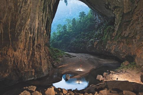 Cavers enter Hang En, a cave tunneled out by the Rao Thuong River.