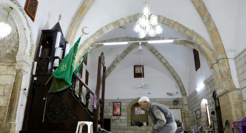 A man prays at Al-Khadra mosque in the old quarter of the West Bank town of Nablus; The Palestinian Authority has imposed a night and weekend curfew on the occupied West Bank for the next 14 days due to COVID-19