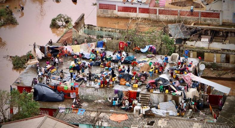 Survivors seek safety on the roof of a house submerged by floods in Mozambique's Buzi town