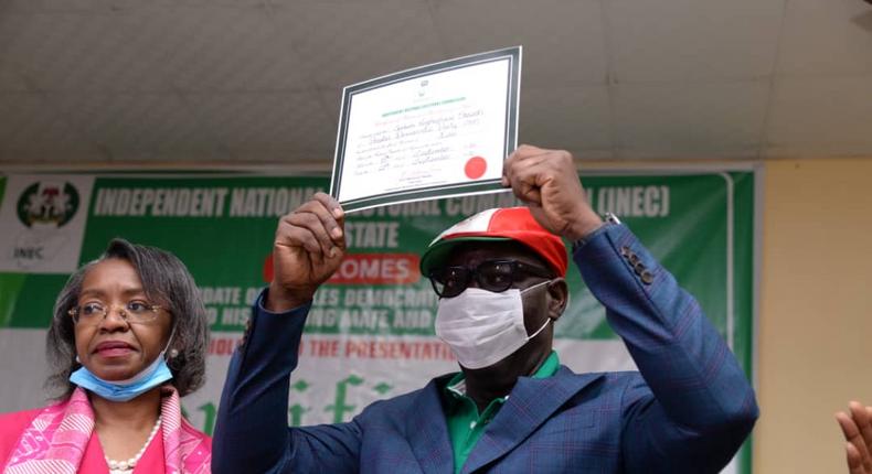 Edo's Governor Godwin Obaseki raises his certificate of return after he was re-elected for a second four-year term in office [Twitter-@GovernorObaseki]