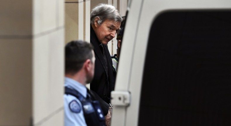 Australian Cardinal George Pell is escorted in handcuffs from the Supreme Court of Victoria in Melbourne on August 21, 2019.