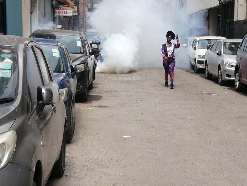 A protestor walks away from teargas during Occupy Parliament protests in Kenya