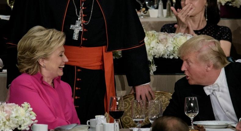 Democratic presidential nominee Hillary Clinton (L) and Republican nominee Donald Trump talk during the Alfred E. Smith Memorial Foundation Dinner at Waldorf Astoria in New York on October 20, 2016