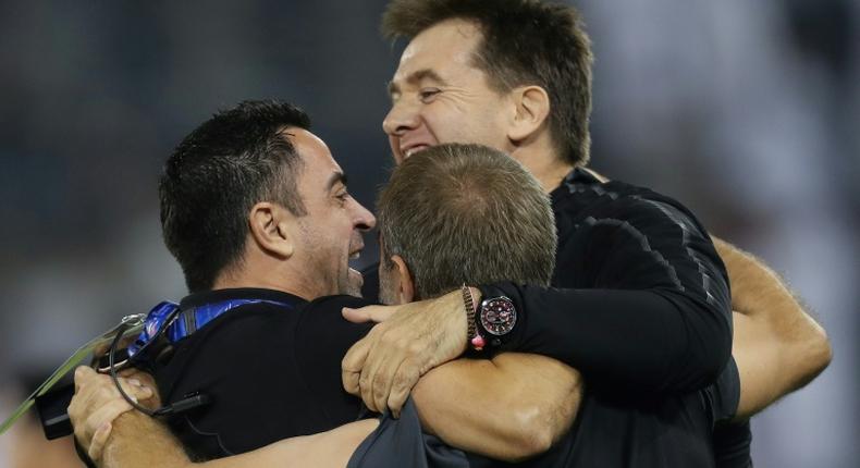 Sadd SC's Spanish coach Xavi Hernandez celebrates with his staff after his team's 3-1 AFC Champions League quarter-final football match victory against Saudi's Al-Nassr at the Jassim bin Hamad Stadium in Doha on September 16, 2019.