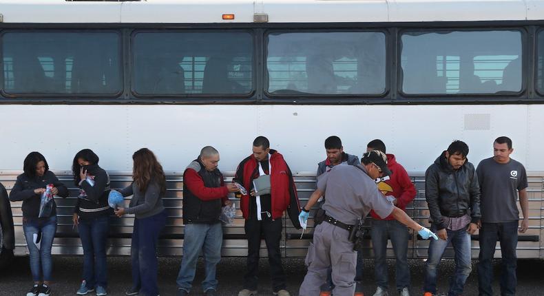 Immigrants collect their belongings in Texas before being deported.