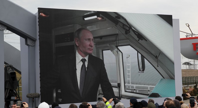 Russian President Vladimir Putin is seen on the screen riding a train across the bridge linking Russia and Crimean Peninsula at Taman railways station on December 23, 2019 near Anapa, Russia.Mikhail Svetlov/Getty Images