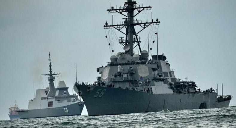 The guided-missile destroyer USS John S. McCain collided with an oil tanker as it headed for a routine stop in Singapore, leaving a gaping hole in its port side and flooding it with water