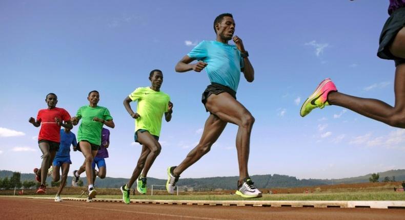 Lelisa Desisa (2nd R) takes part in a practice session on the outskirts of Addis Ababa in March