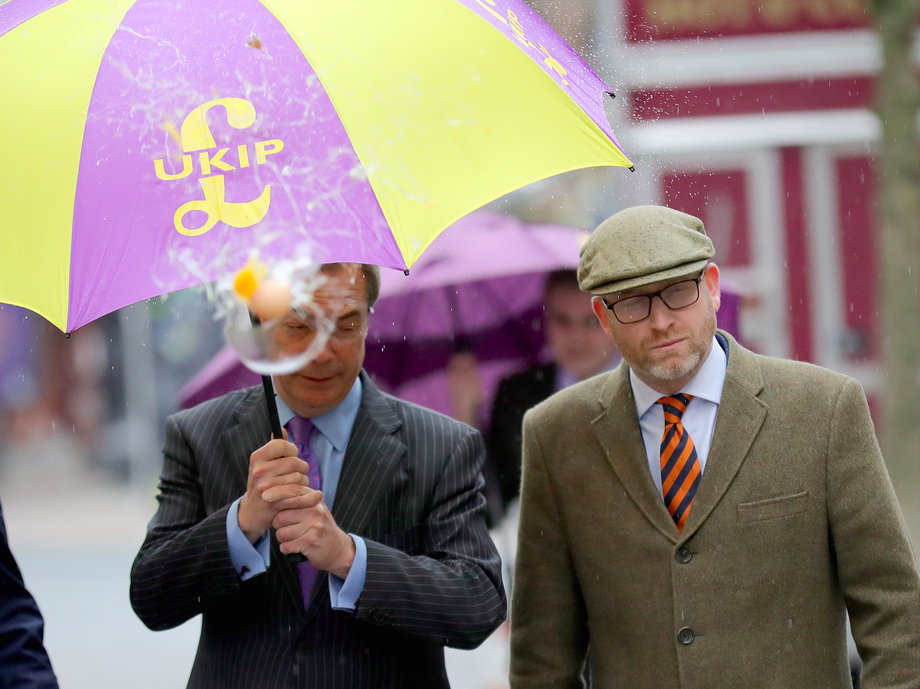 UKIP leader Paul Nuttall (R) and former Leader Nigel Farage MEP dodge an egg thrown by a youth as they arrive in Stoke-On-Trent.