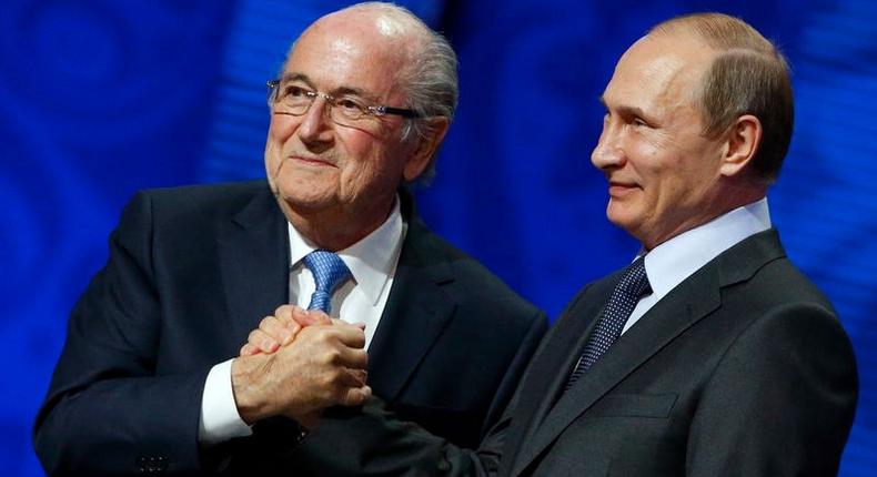 FIFA's President Sepp Blatter shakes hands with Russia's President Vladimir Putin (R) during the preliminary draw for the 2018 FIFA World Cup at Konstantin Palace in St. Petersburg, Russia July 25, 2015. REUTERS/Grigory Dukor