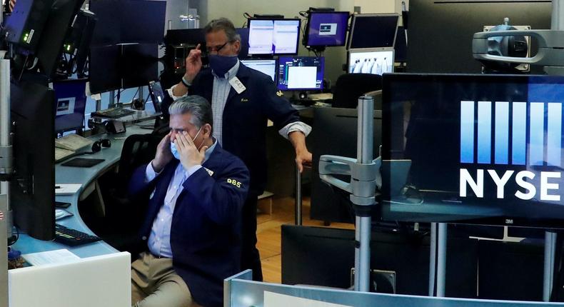 FILE PHOTO: Traders wear masks as they work on the floor of the New York Stock Exchange as the outbreak of the coronavirus disease (COVID-19) continues in the Manhattan borough of New York, U.S., May 27, 2020. REUTERS/Lucas Jackson     TPX IMAGES OF THE DAY