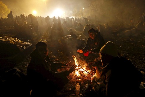 Migrants wait to cross the Slovenia-Austria border in Sentilj