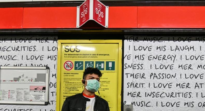 A man wearing a respiratory mask in the Milan subway.