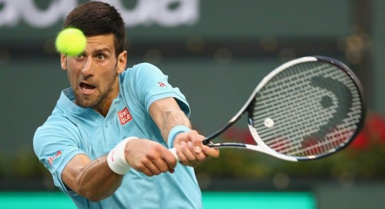 Novak Djokovic of Serbia plays a backhand against Kyle Edmund of Britain during their BNP Paribas Open second round match, at Indian Wells Tennis Garden in California, on March 12, 2017